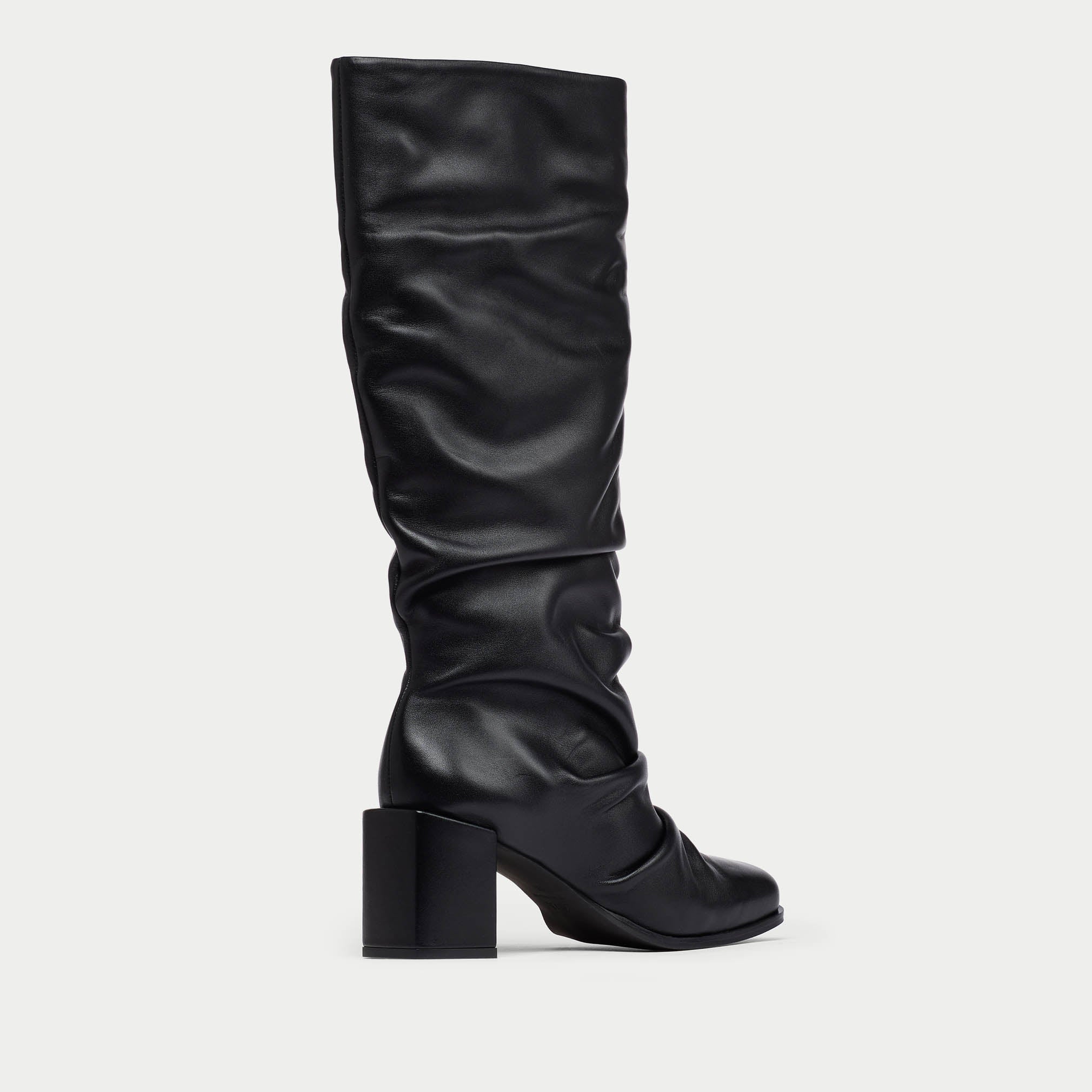 Black knee-high boot on a light gray background