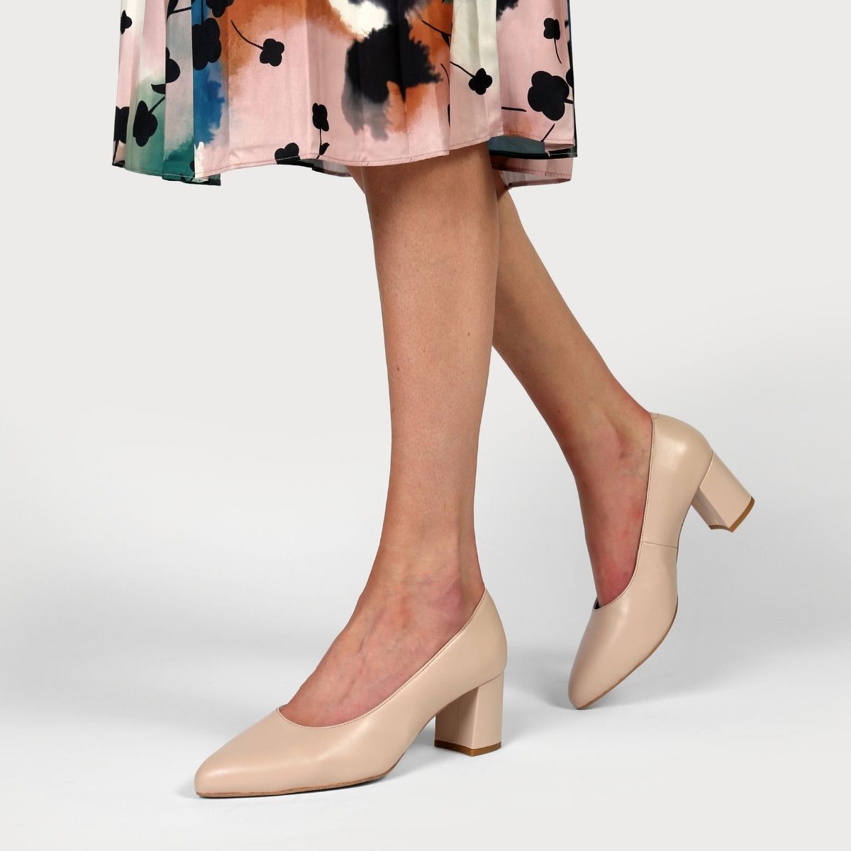 nude leather court shoe worn with a floral skirt