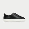 Black leather slip-on sneaker on a light gray background