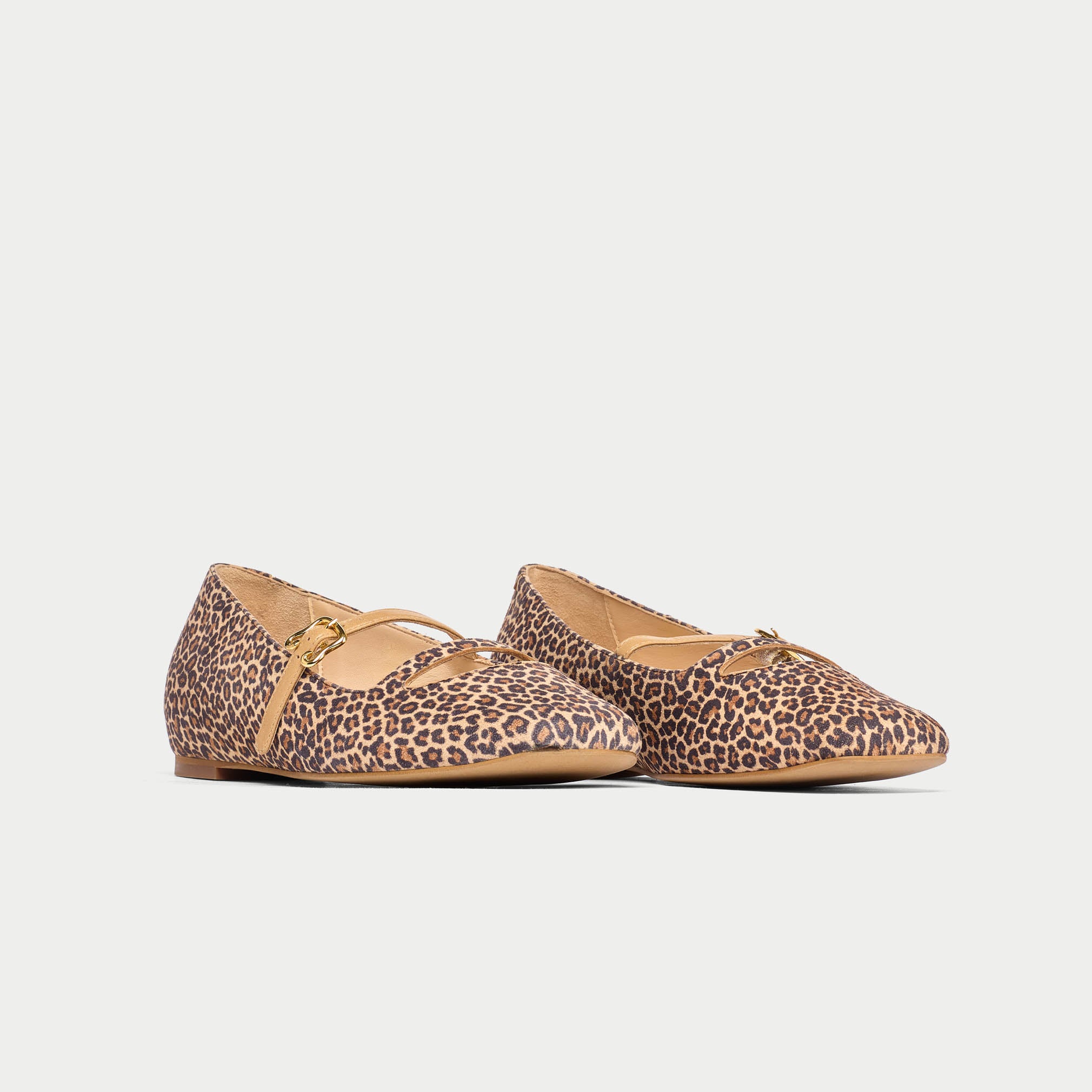 Pair of leopard print flats on a light gray background