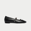 Black platform shoe with a strap on a white background