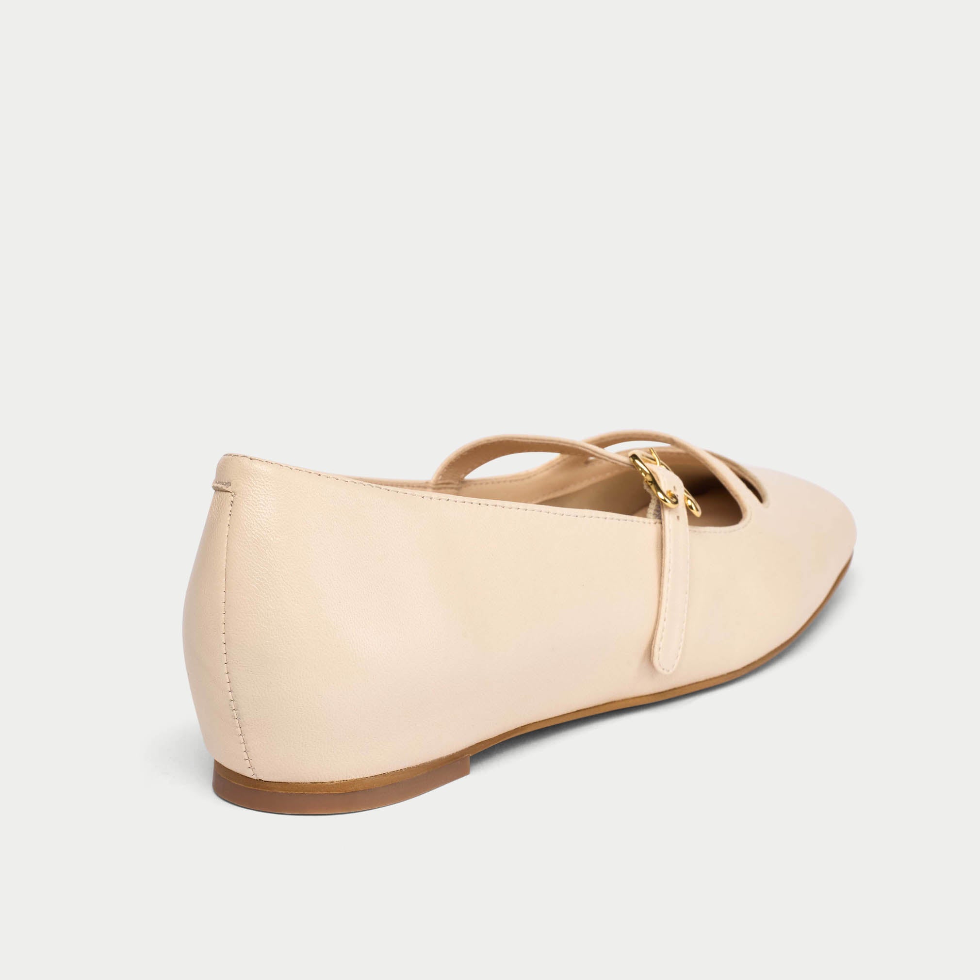 Beige flat shoe with a bow on a light gray background