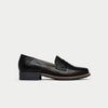 Black loafer shoe on a light gray background