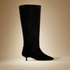 Black knee-high boot on a gold background