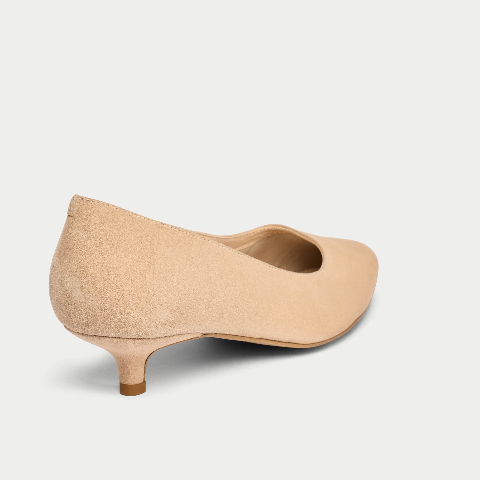 Beige low heel shoe on a light gray background