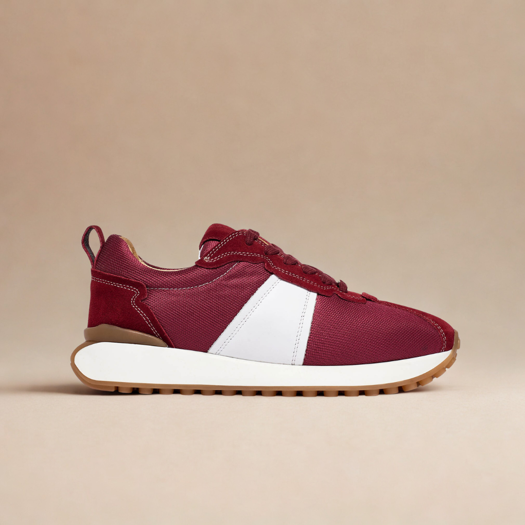 burgundy sneakers with white sole on a beige background