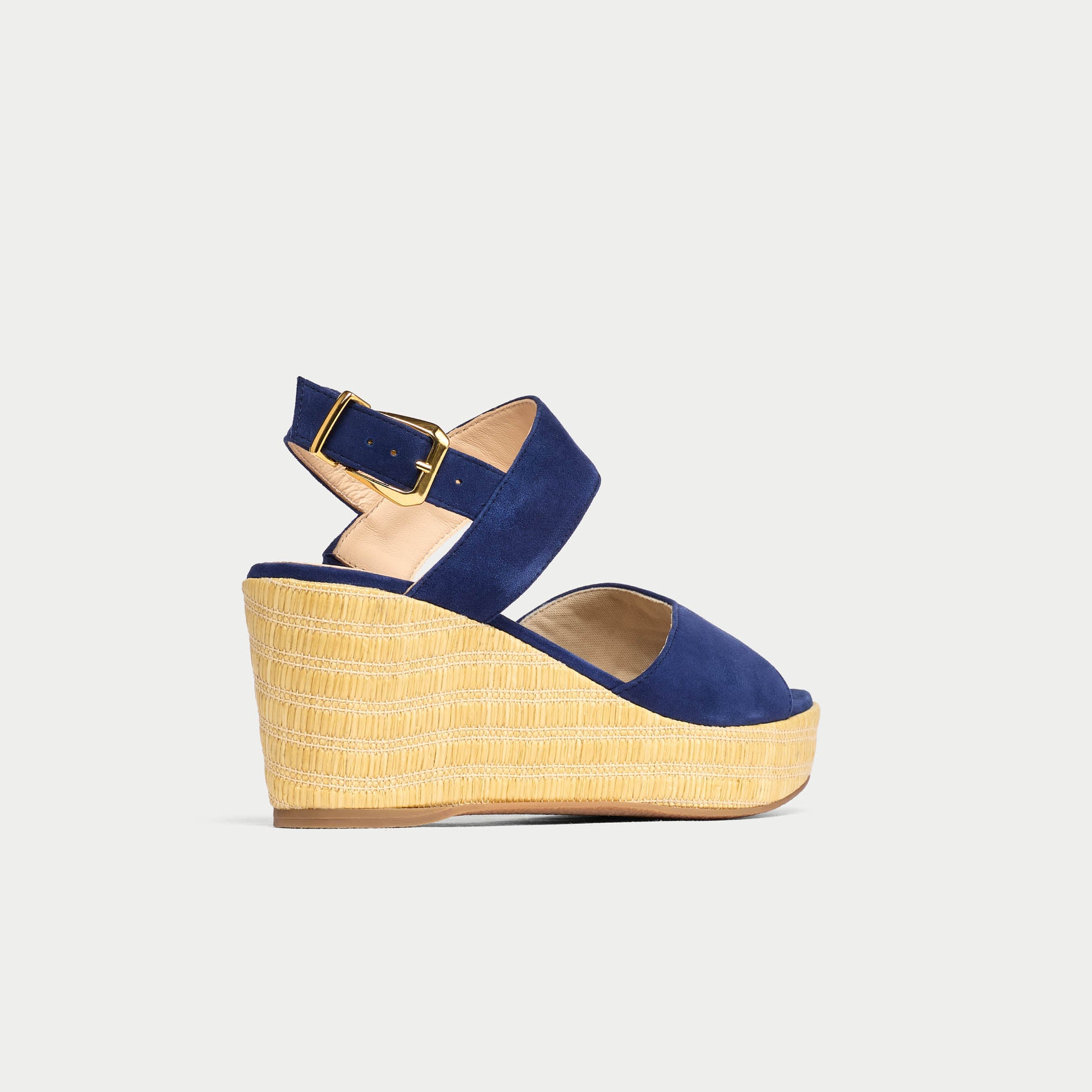 Blue wedge sandal with yellow sole on a light gray background