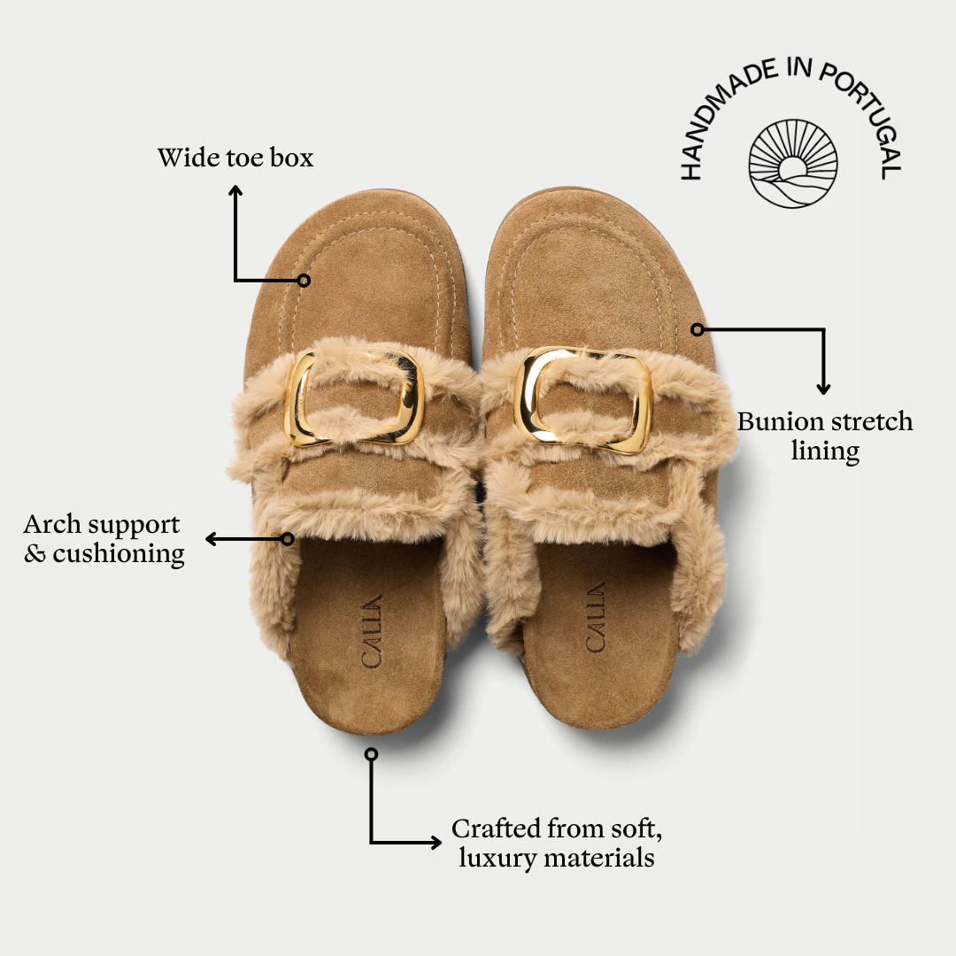 Pair of tan slippers with features highlighted on a white background