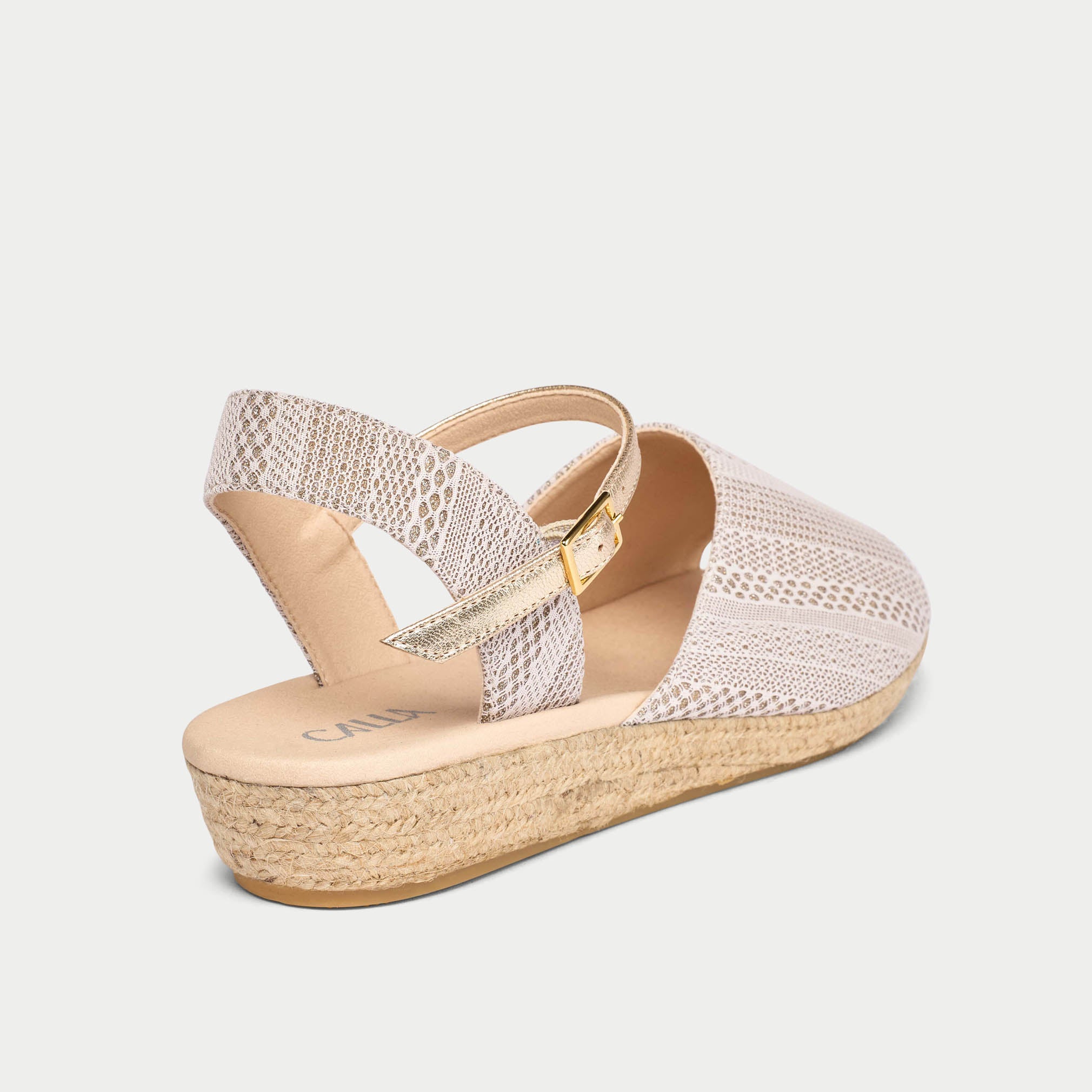 Wedge sandal with woven sole on a light gray background