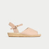 Beige sandal with a wedge sole on a light gray background