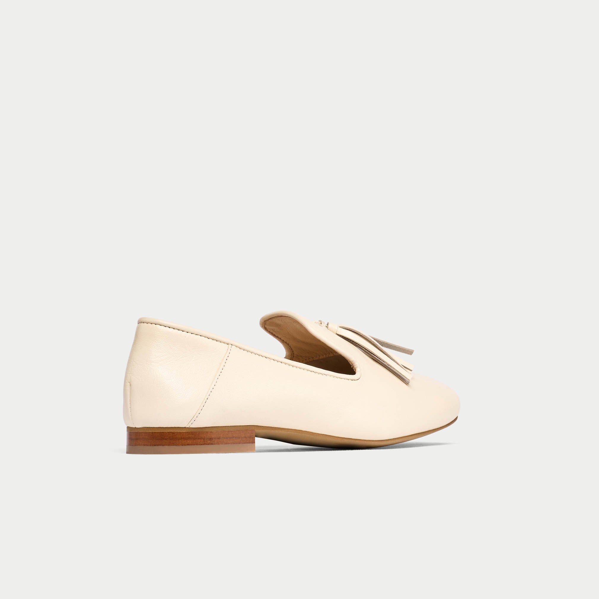 Beige loafer shoe on a light gray background