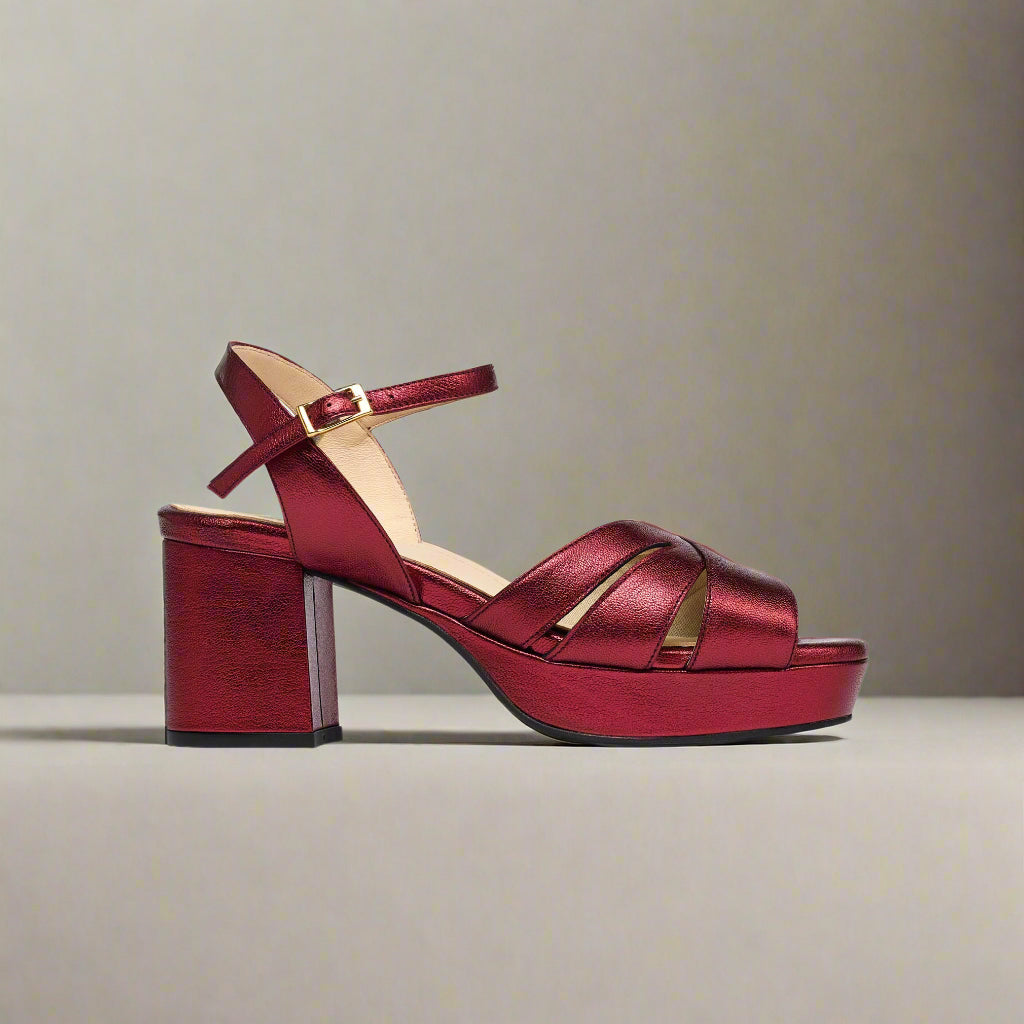 Red high-heeled sandal on a light gray background