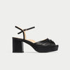 Black platform sandal on a light gray background