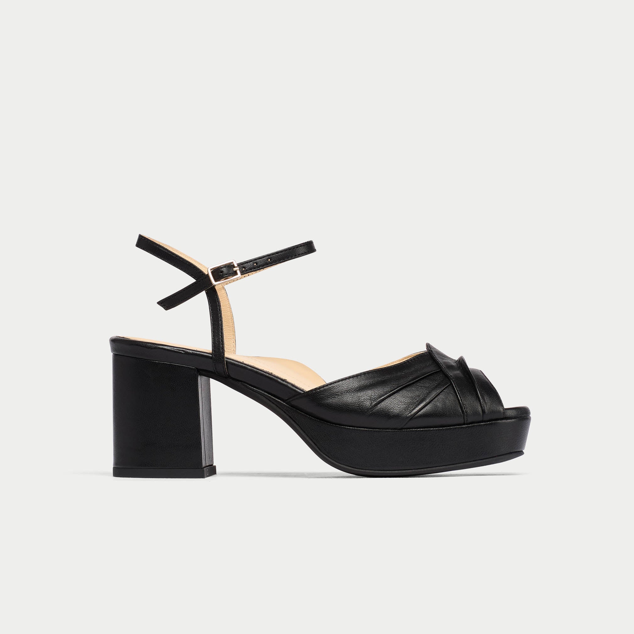 Black platform sandal on a light gray background
