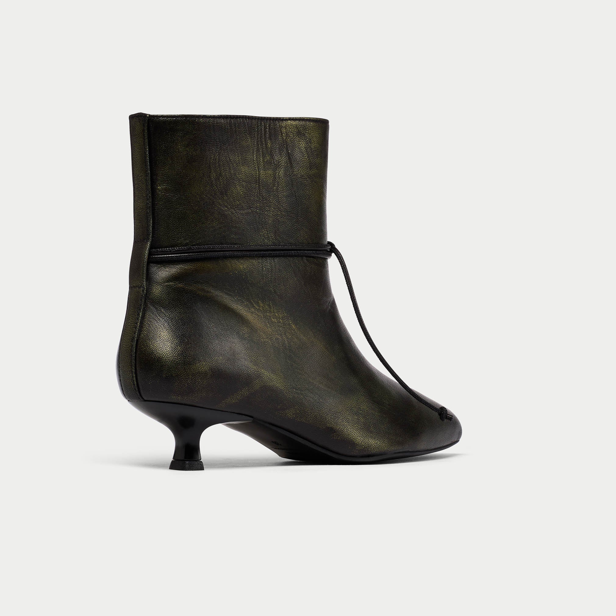 Black ankle boot with a thin heel on a light gray background