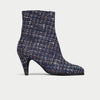 Navy blue tweed ankle boot on a light gray background
