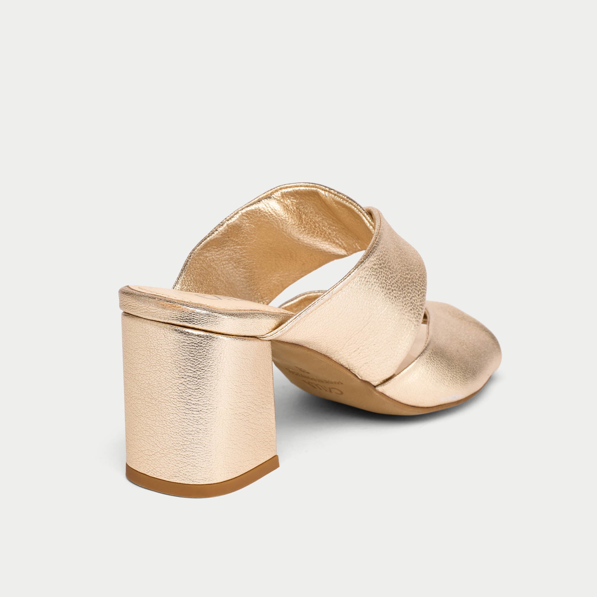 Gold wedge sandal on a light gray background