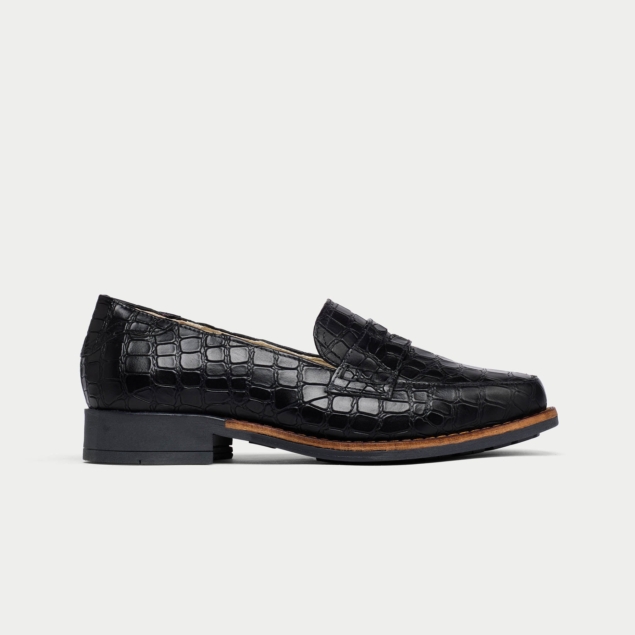 Black Nadia crocodile-patterned loafer on a light gray background side view