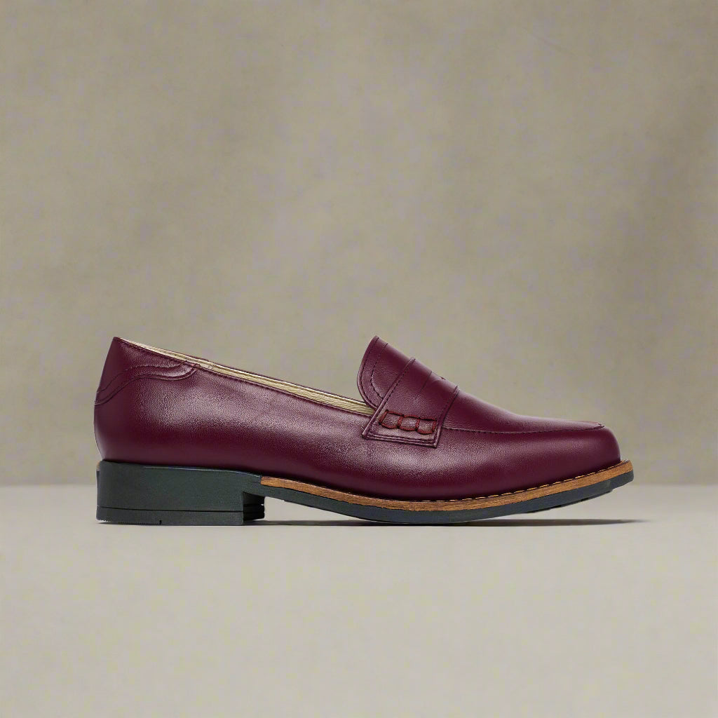Black Nadia crocodile-patterned loafer on a light gray background