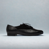 Black leather shoes on a light gray background