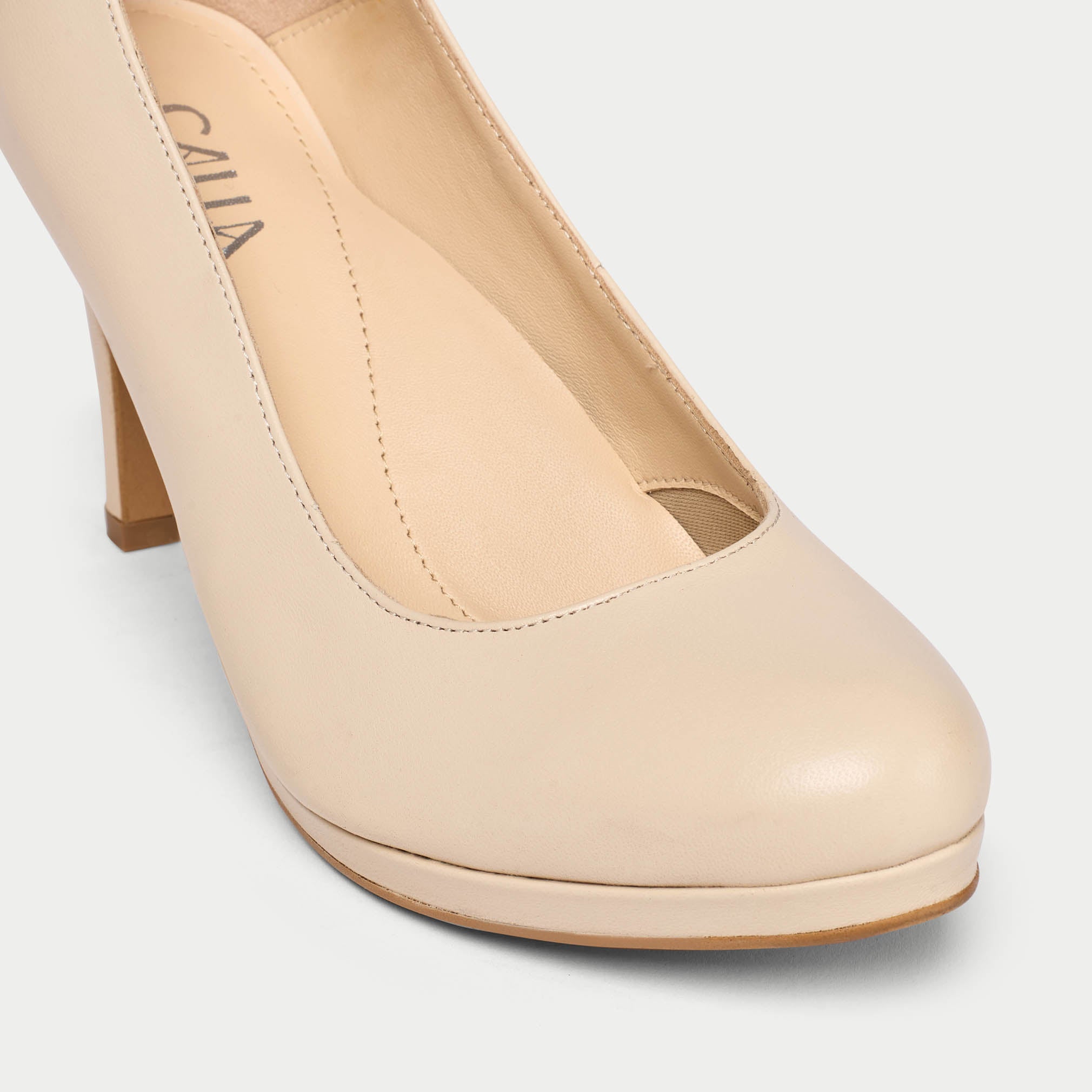 Beige high-heeled shoe with 'Calla' branding on a light gray background