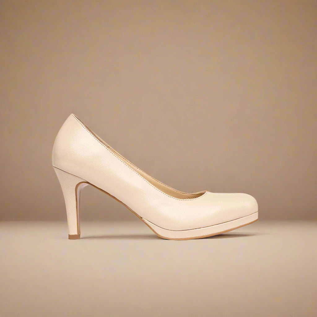 Beige high-heeled shoe on a beige background
