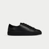 Black leather sneaker on a light gray background