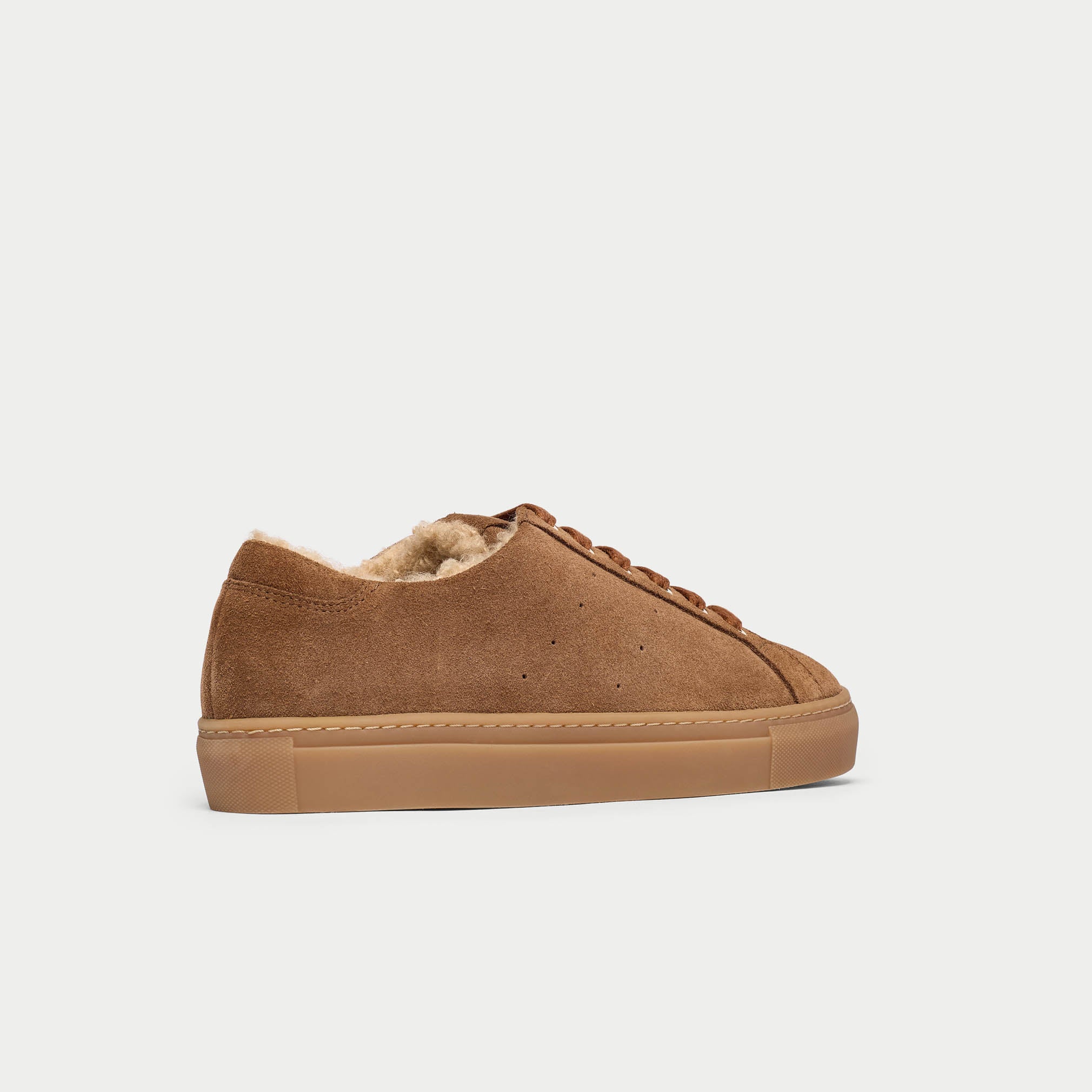 Brown sneaker with shearling lining on a light gray background