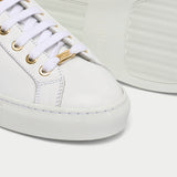 close up of star white and metallic gold sneakers for bunions