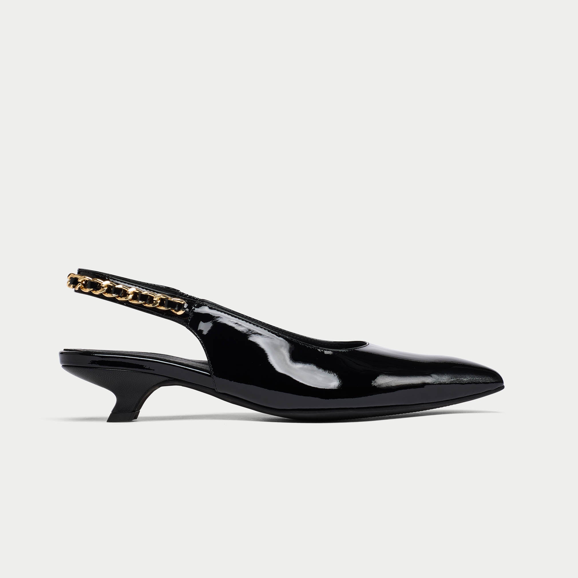 Black Thea patent leather slingback shoe with gold chain detail on a white background side view