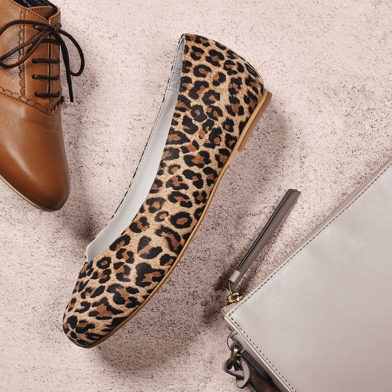 leopard suede flat shoe on concrete background