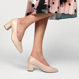 nude leather heeled dress shoe worn with a floral skirt