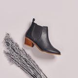 dark grey leather boots on grey background