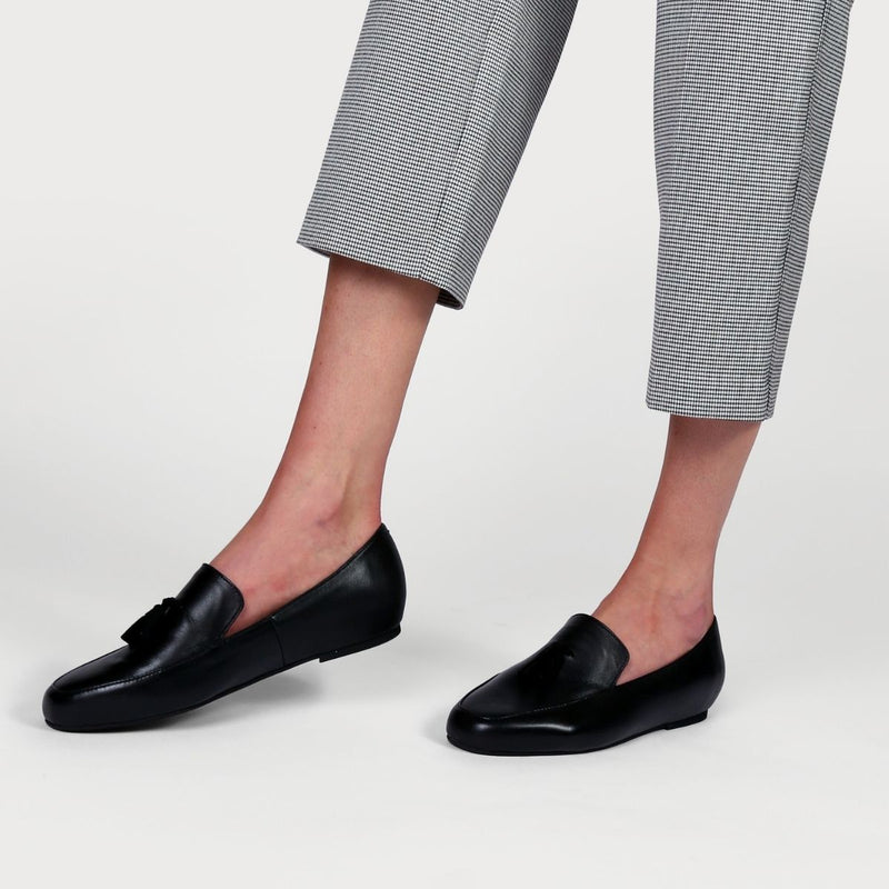 black leather loafers worn with checked trousers