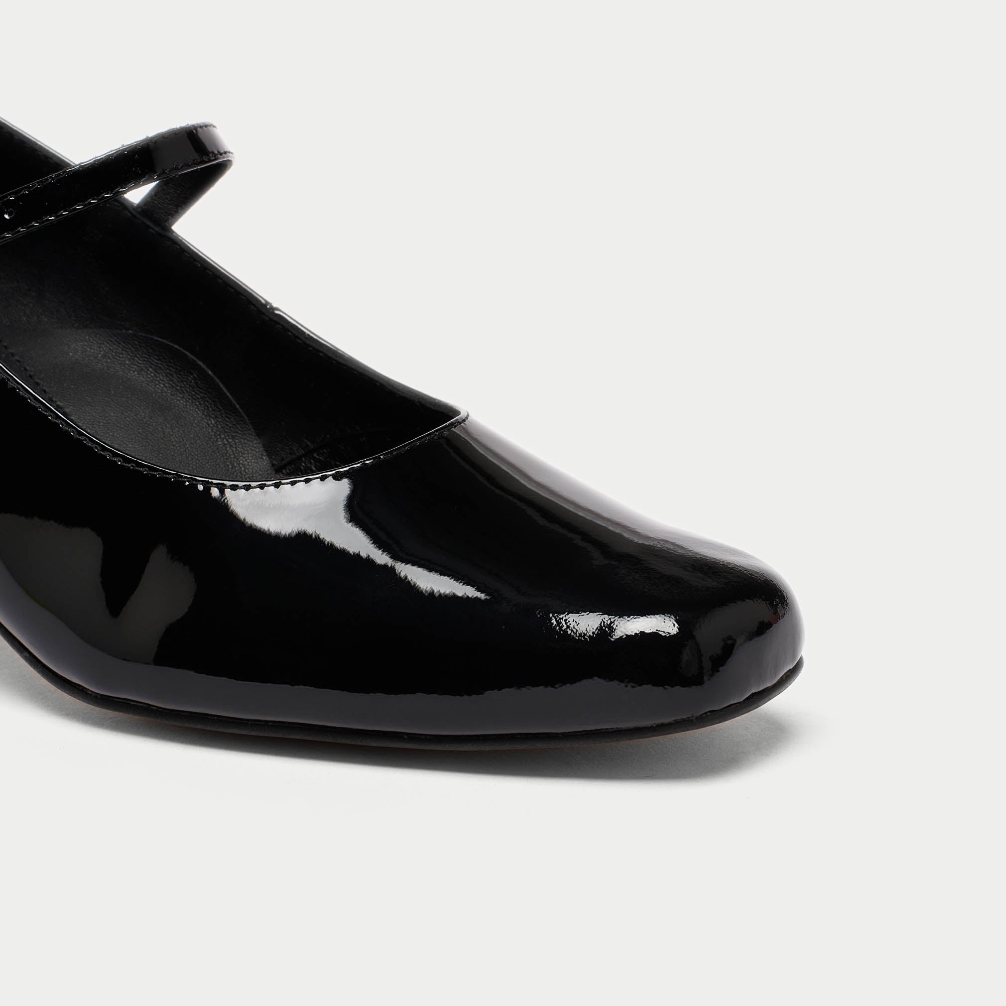 black patent leather mary janes close up 