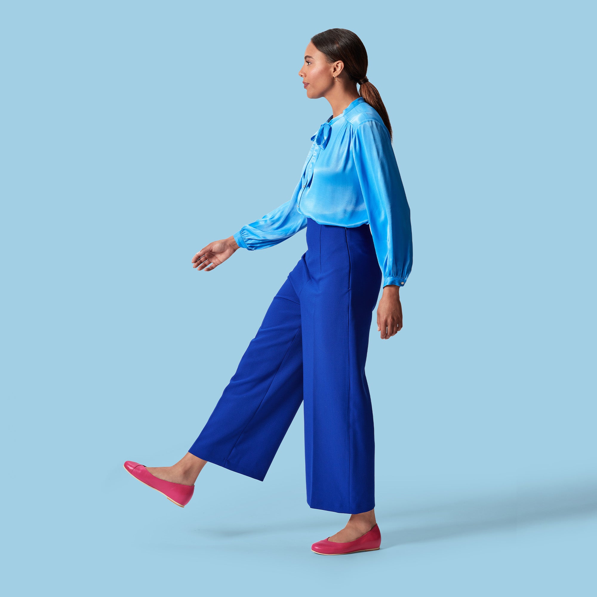model walking wearing all blue and pink shoes