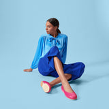 model wearing blue outfit and raspberry pink ballet flats by Calla shoes