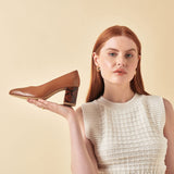model holding calla sara block heels